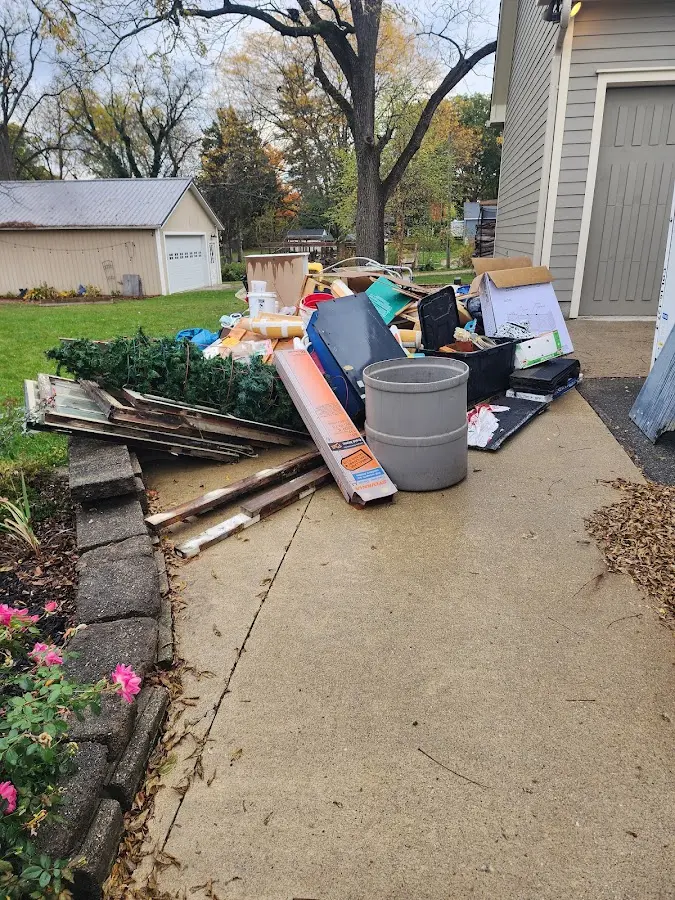 Dumpster being loaded with debris for Estate Cleanout Dumpster Rental in Avery Creek